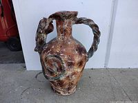 Front view showing overall form, patina, spiral relief and figural handle