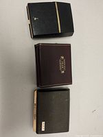 Closed hard cases for each shaver showing exterior colors and branding