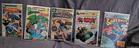 Five bagged comics laid out side-by-side showing all covers