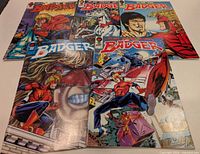 Five Badger comics fanned out showing covers