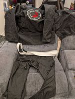 Full gi laid out showing jacket, pants and white belt