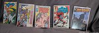 Five bagged comics laid out: Alpha Flight, X-Force 10, X-Force 38, Red Sonja, Joe Golem Occult Detective