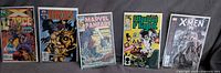 Front covers of all five bagged comics side by side