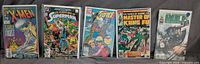 Front view of all five bagged and boarded comics