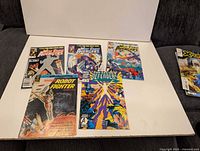 All six comics laid out