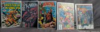 Front view of all five bagged comics standing side by side