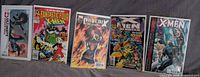 Group shot of five bagged comic issues