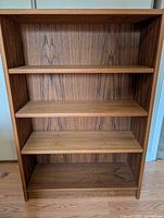 Front view showing four shelves and woodgrain finish