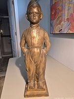 Front view of bronze Dutch boy stand