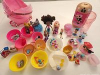 Overall lot with dolls, pets, ball shells, large pink case and accessories spread out