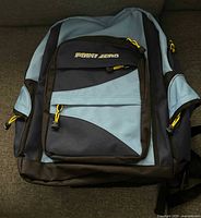 Front view showing Point Zero logo, three front zip pockets, yellow zipper pulls