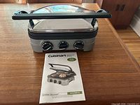 Grill closed with manual on table