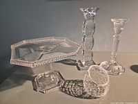 Group shot showing cake stand, two candlesticks, votive