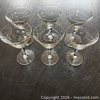 Group of six etched crystal sherry glasses, front view