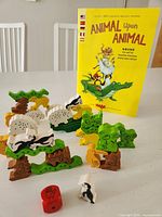 Wooden animal pieces, red die and instruction booklet for Animal Upon Animal