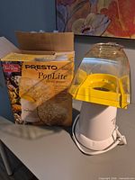 Popper with box showing branding and model