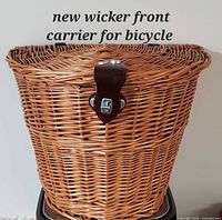 Front view showing wicker construction and lid clasp