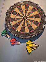 Front of dartboard with darts arranged