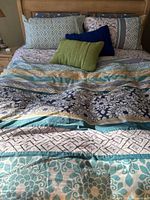 Full bed showing duvet cover, matching pillow slips, decorative pillows