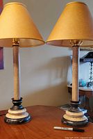 Front view of both matching lamps with shades on tabletop