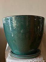 Front view of green glazed planter with saucer