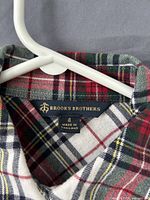 Brand label showing Brooks Brothers, size 4, made in Thailand, plaid fabric detail