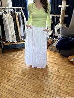 Front view of white linen skirt worn by model