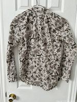 Front view of ivory floral Ralph Lauren blouse on hanger