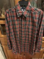 Full front view of plaid shirt on hanger