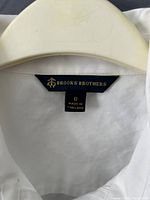 Brooks Brothers neck label showing brand, size 6, made in Thailand