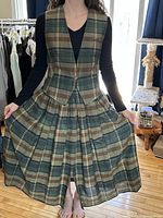 Model wearing matching plaid vest and skirt front view