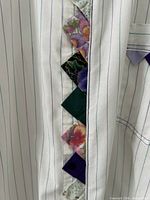 Front placket showing white fabric with green/purple stripes and patchwork diamond inserts