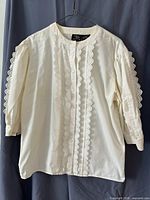 Front view of blouse showing lace trim, button front, overall condition