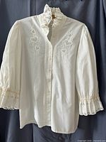 Front view of white embroidered blouse