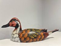 Left-side view of full wooden duck showing painted feather details