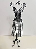 Full view of black wire dress form jewellery holder on scrolled base