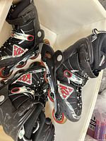 Both pairs of K2 Raider kids inline skates showing overall appearance and wheels