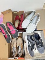 All five pairs of women’s shoes displayed in boxes