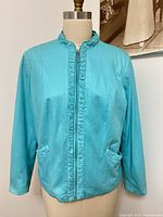 Front view showing ruched trim, zipper, pockets