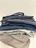 Stack of folded pants showing variety of colours