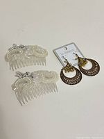 Overall view: two beaded hair combs and Le Château earrings on card