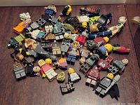 Pile of assorted LEGO minifigure parts and some assembled figures