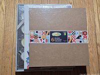 Stack topped by sealed Craft 6-pack boards, additional items partly visible underneath