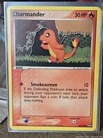 Front of sleeved Charmander card showing set details and condition