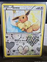 Front of Eevee RC14/RC25 holo card in sleeve