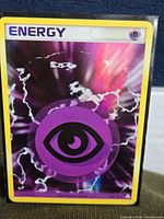 Front of Pokémon Psychic Energy holo card in sleeve