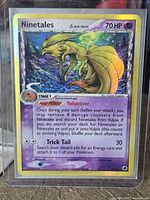 Front view of Ninetales holographic card in protective sleeve