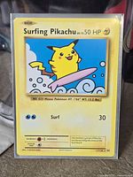 Front of Surfing Pikachu card in protective sleeve