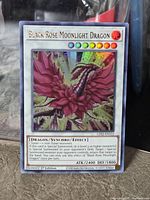 Front of Black Rose Moonlight Dragon card showing artwork, text, stats, set code