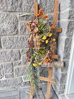 Full view of wood frame sign with floral swag